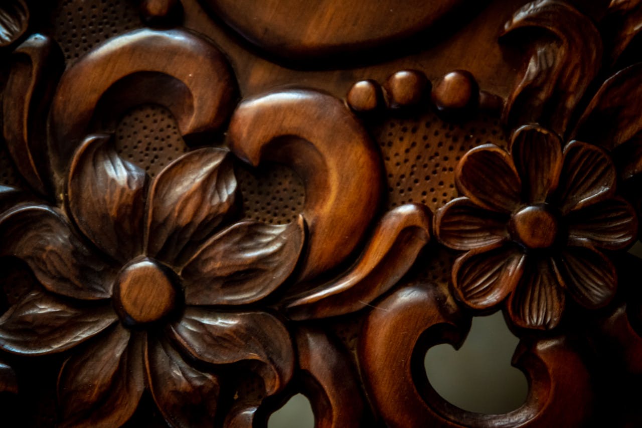 Close-up of vintage floral wood carving with decorative patterns, showcasing craftsmanship.